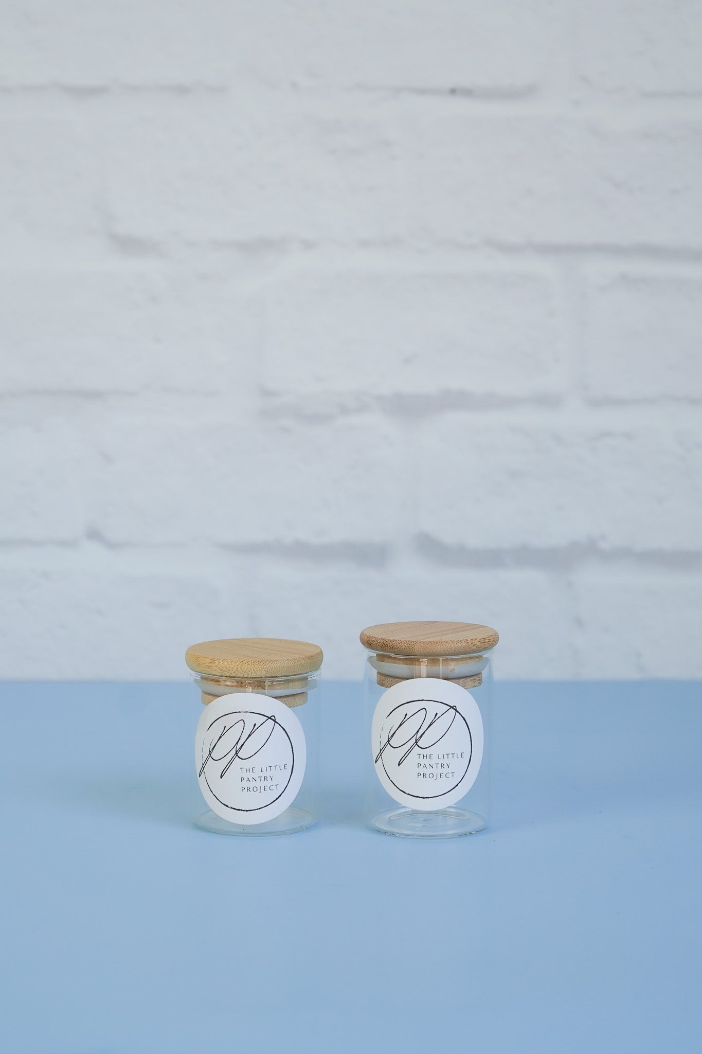 Two bamboo lid spice jar glass canisters from The Little Pantry Project.