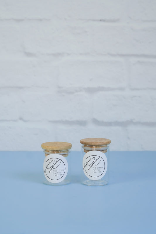 Two bamboo lid spice jar glass canisters from The Little Pantry Project.