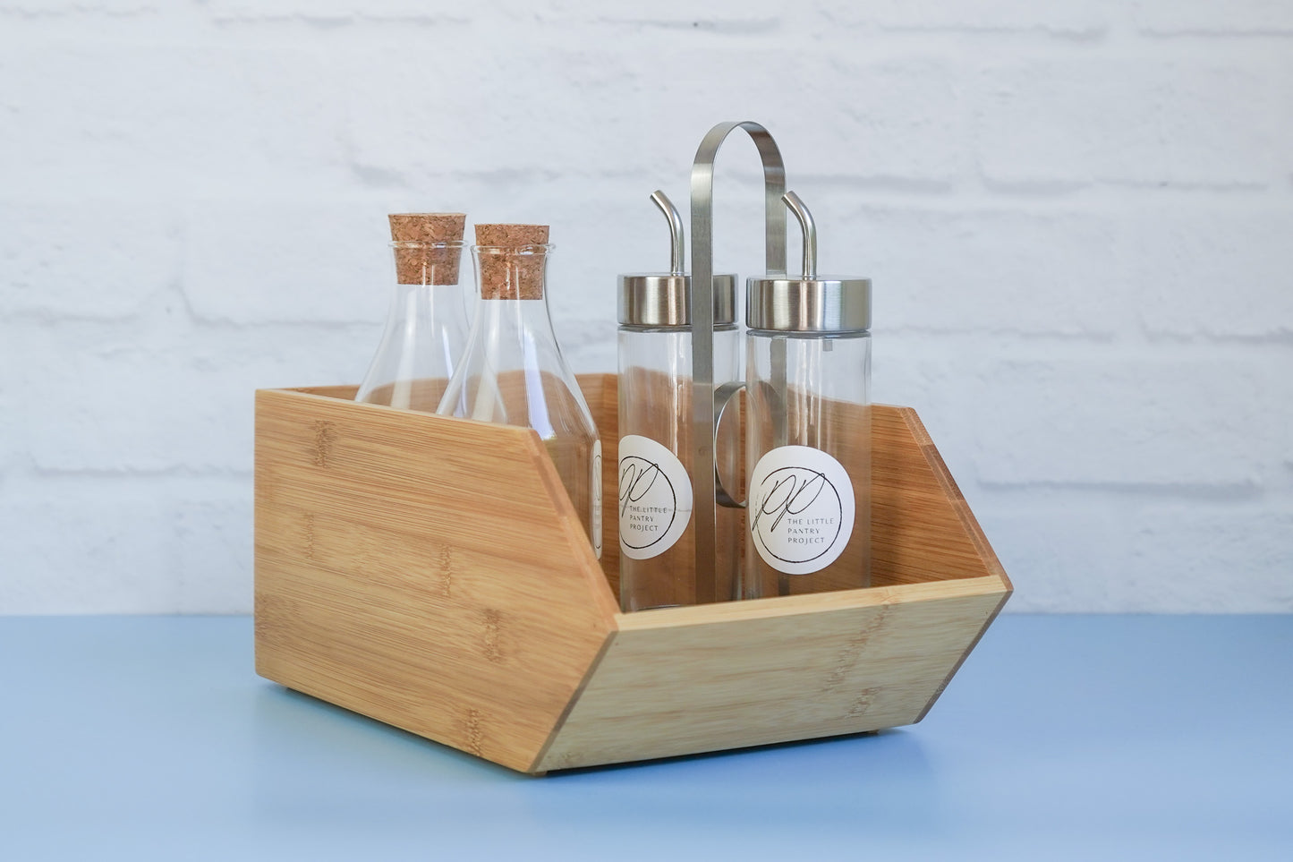The bamboo stackable box from The Little Pantry Project with oil dispensers inside.