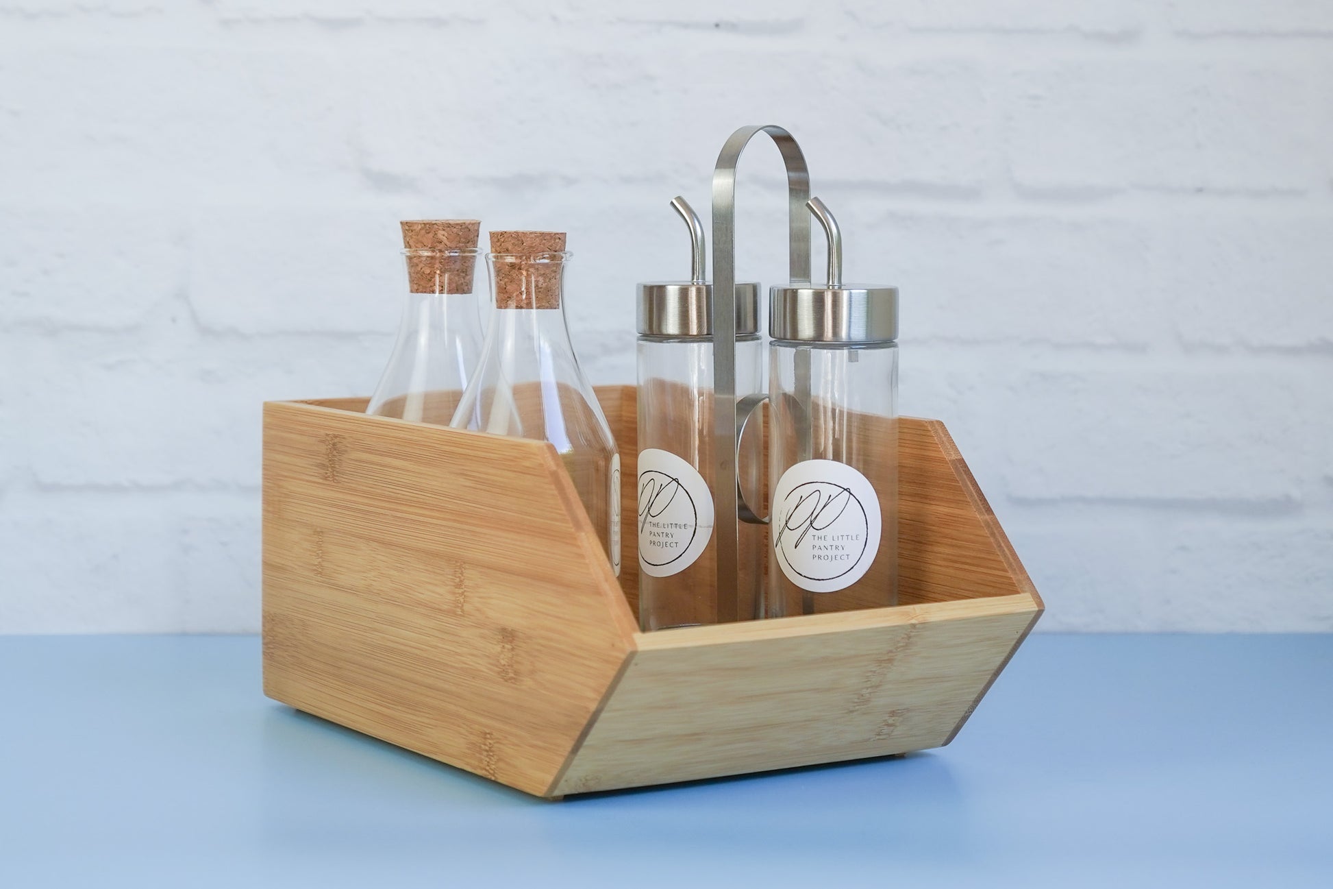 The bamboo stackable box from The Little Pantry Project with oil dispensers inside.