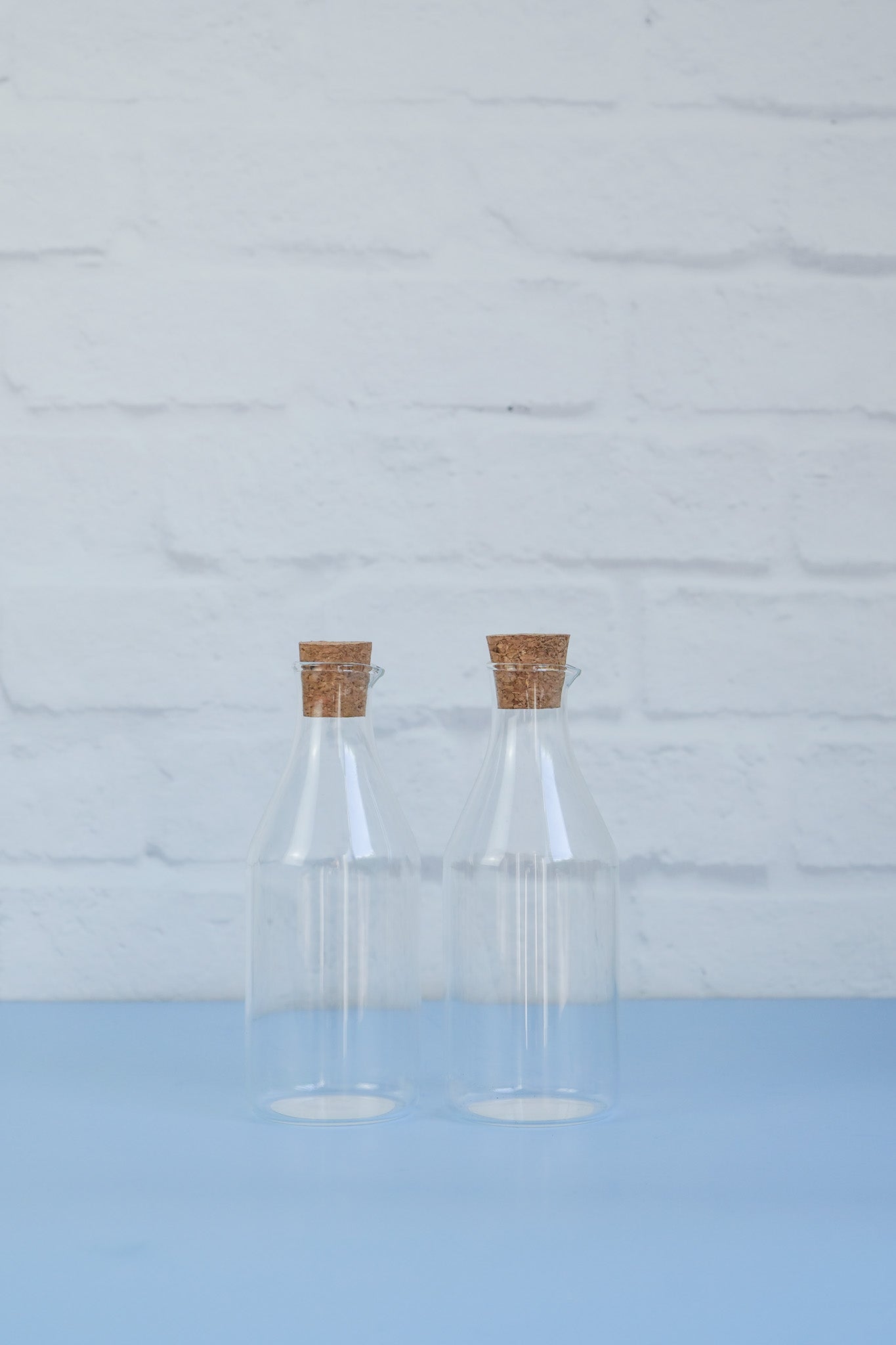 A set of two glass 430ml oil/vinegar bottles with cork tops from The Little Pantry Project.
