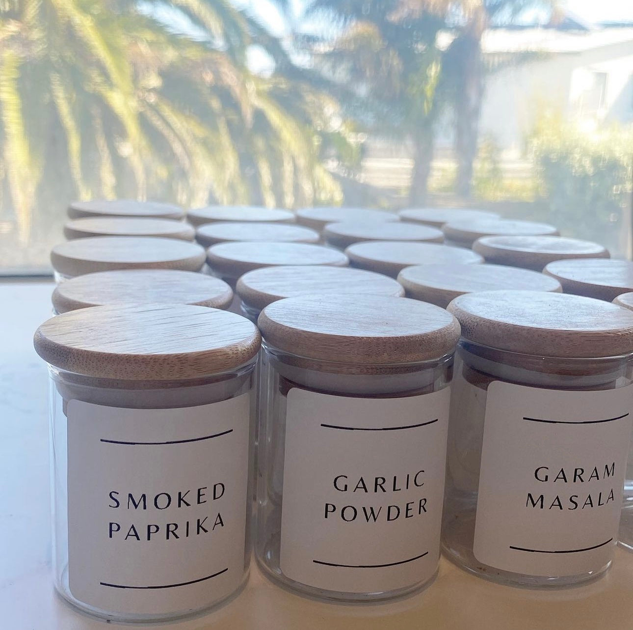 The Little Pantry Projects glass spice jars with labels on them.