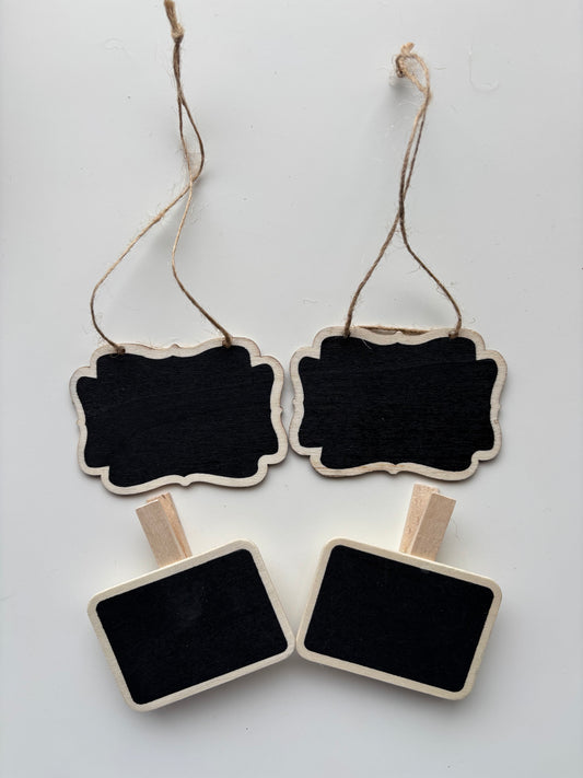 Four wooden chalk labels from The Little Pantry Project. Two with string hangers and two with pegs.