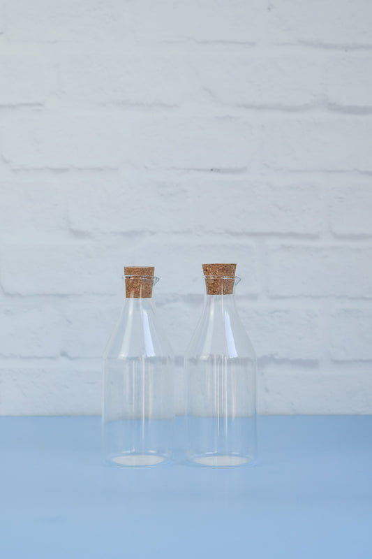 A set of two glass 430ml oil/vinegar bottles with cork tops from The Little Pantry Project.